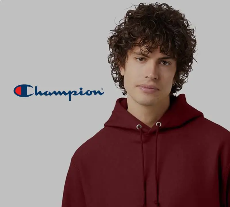 Man wearing a Champion hoodie, an example of the best custom merchandise for businesses