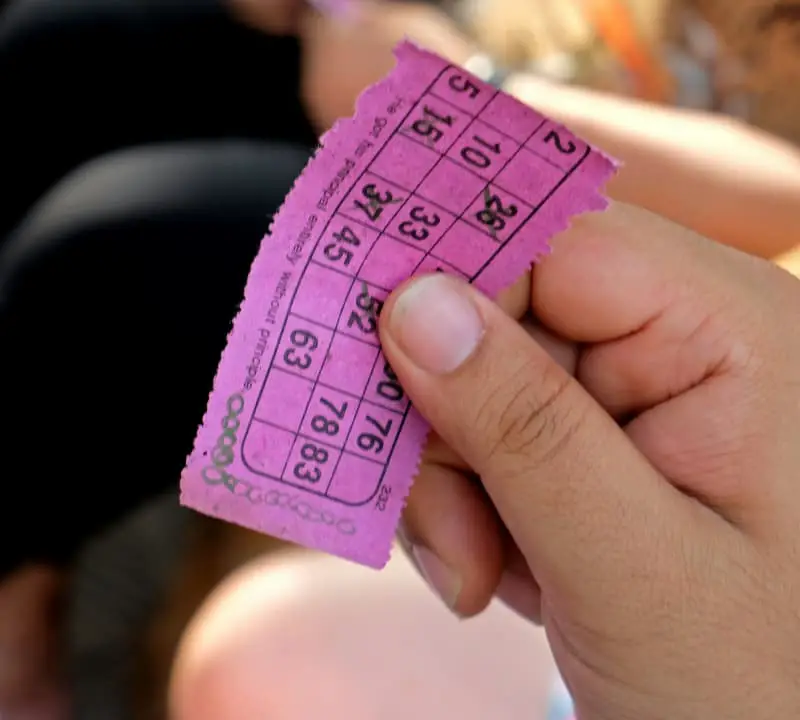 person holding a raffle ticket