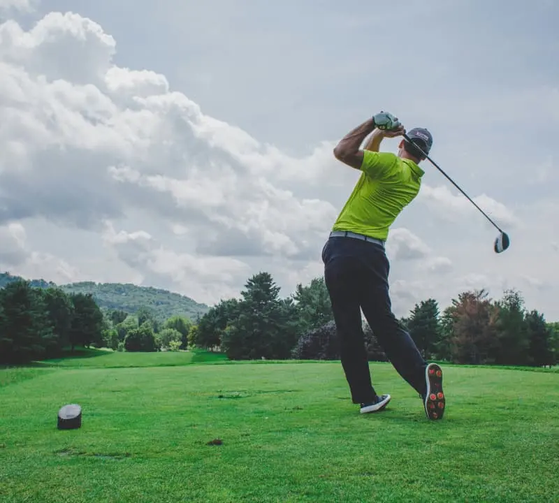 Man golfing in custom golf apparel